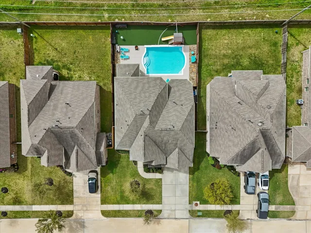 an aerial view of houses with outdoor space
