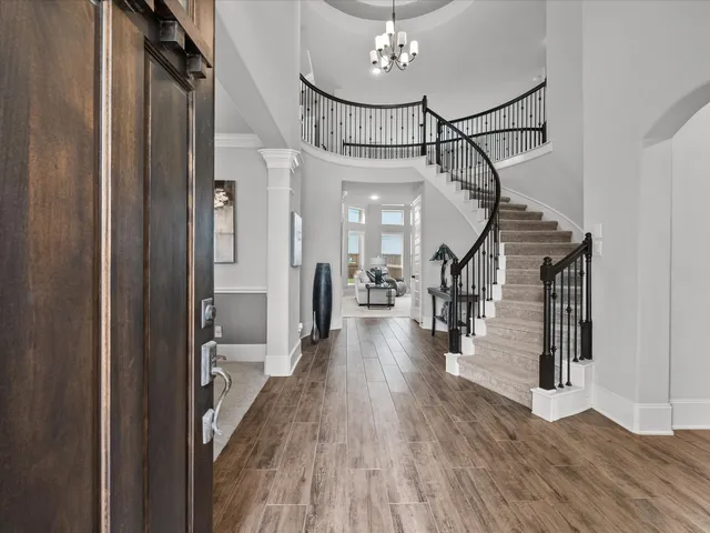 a view of a hallway view with wooden floor and staircase
