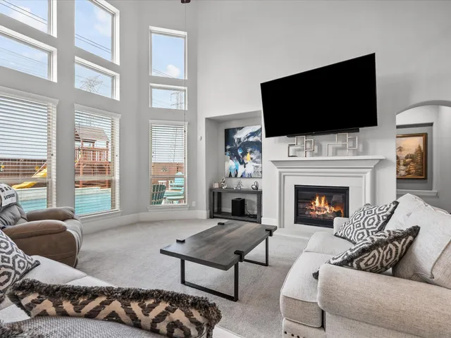 a living room with furniture fireplace and flat screen tv