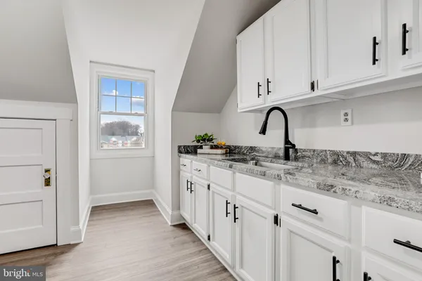 a kitchen with stainless steel appliances granite countertop a sink and cabinets