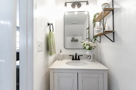 a bathroom with a sink and a mirror