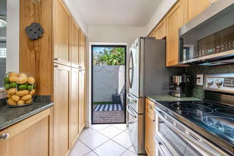 a kitchen with stainless steel appliances granite countertop a refrigerator and a stove