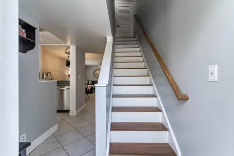 a view of entryway and hall with wooden floor
