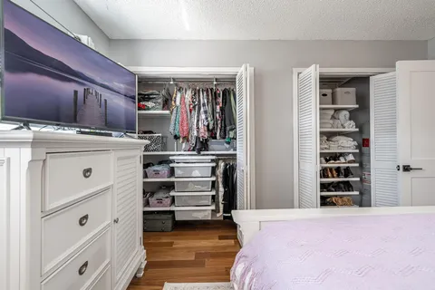 a bedroom with a bed and closet