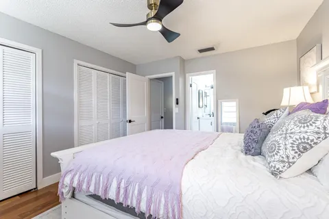 a bedroom with a large bed and a chandelier