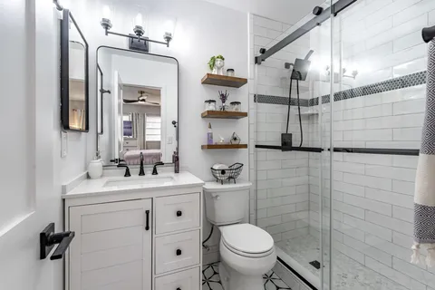 a bathroom with a sink toilet and shower