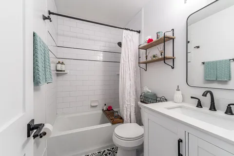 a bathroom with a sink toilet and shower