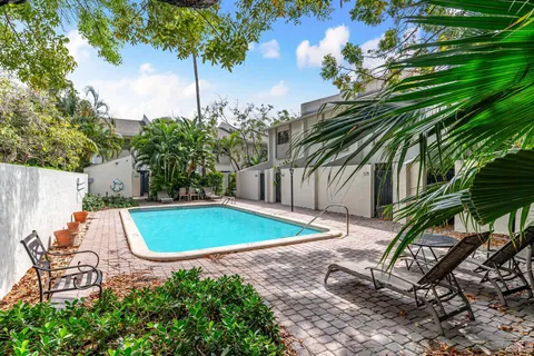 a view of a backyard with plants and a patio