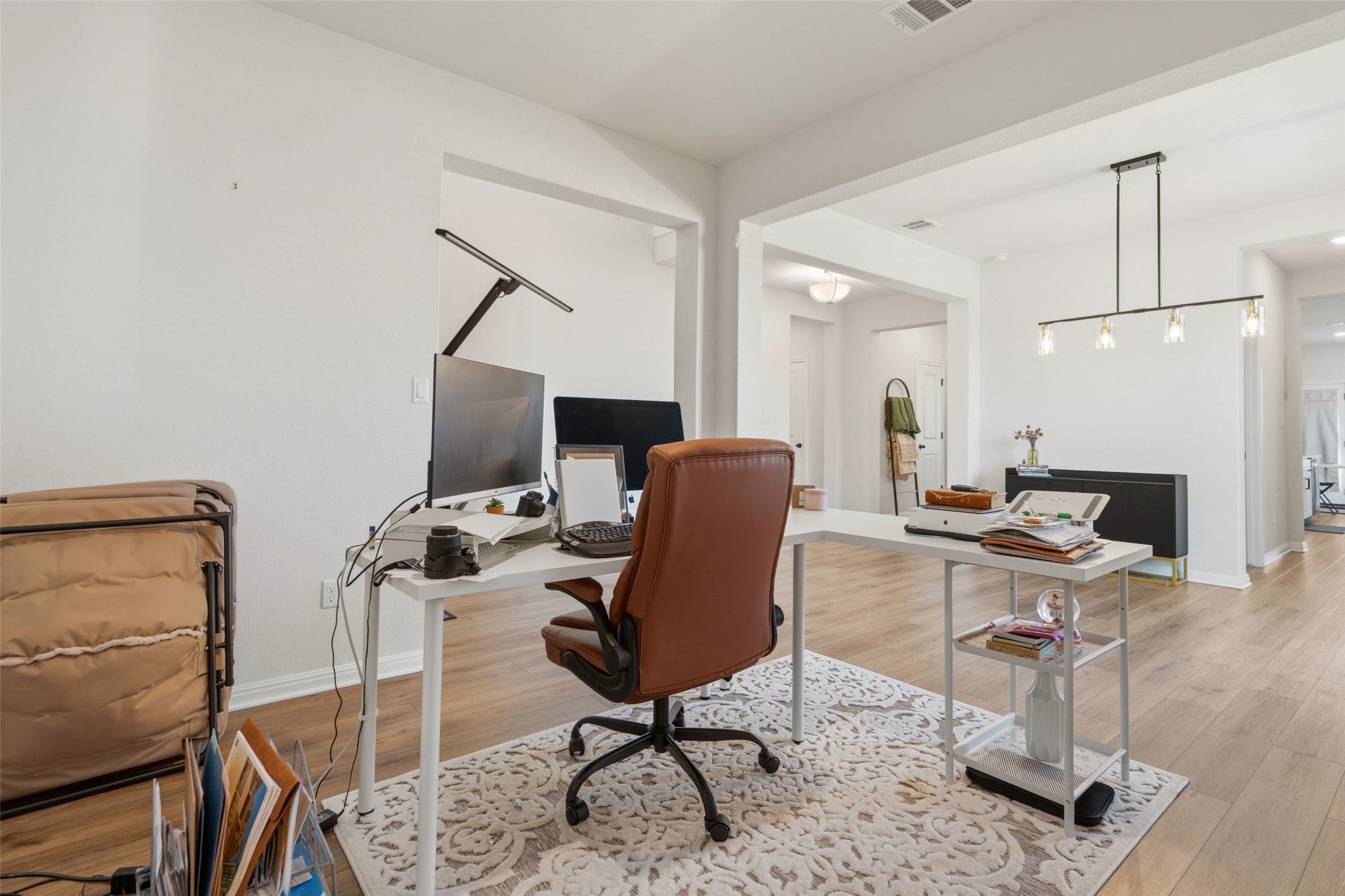 100 Panico Road Hutto, TX 78634 - Photo 14 of 28 A well-lit, open-concept study area with durable wood flooring provides an inviting workspace.