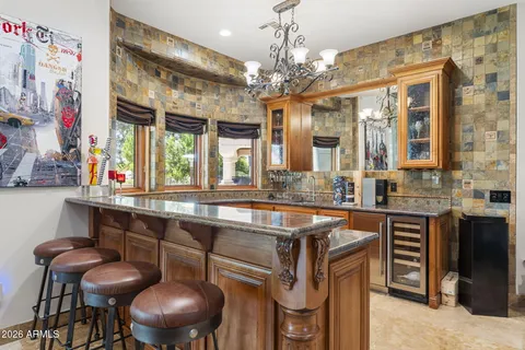 a kitchen with stainless steel appliances granite countertop a sink and a refrigerator
