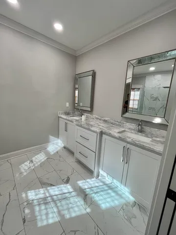 a bathroom with a sink vanity and mirror