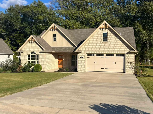 a view of a house with a yard and garage