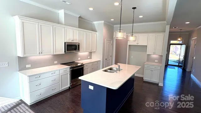 a kitchen with a sink stove and refrigerator