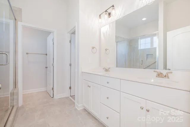 a bathroom with double vanity sink and mirror