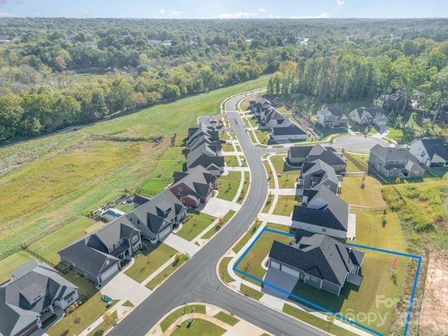 an aerial view of a house with a lake view
