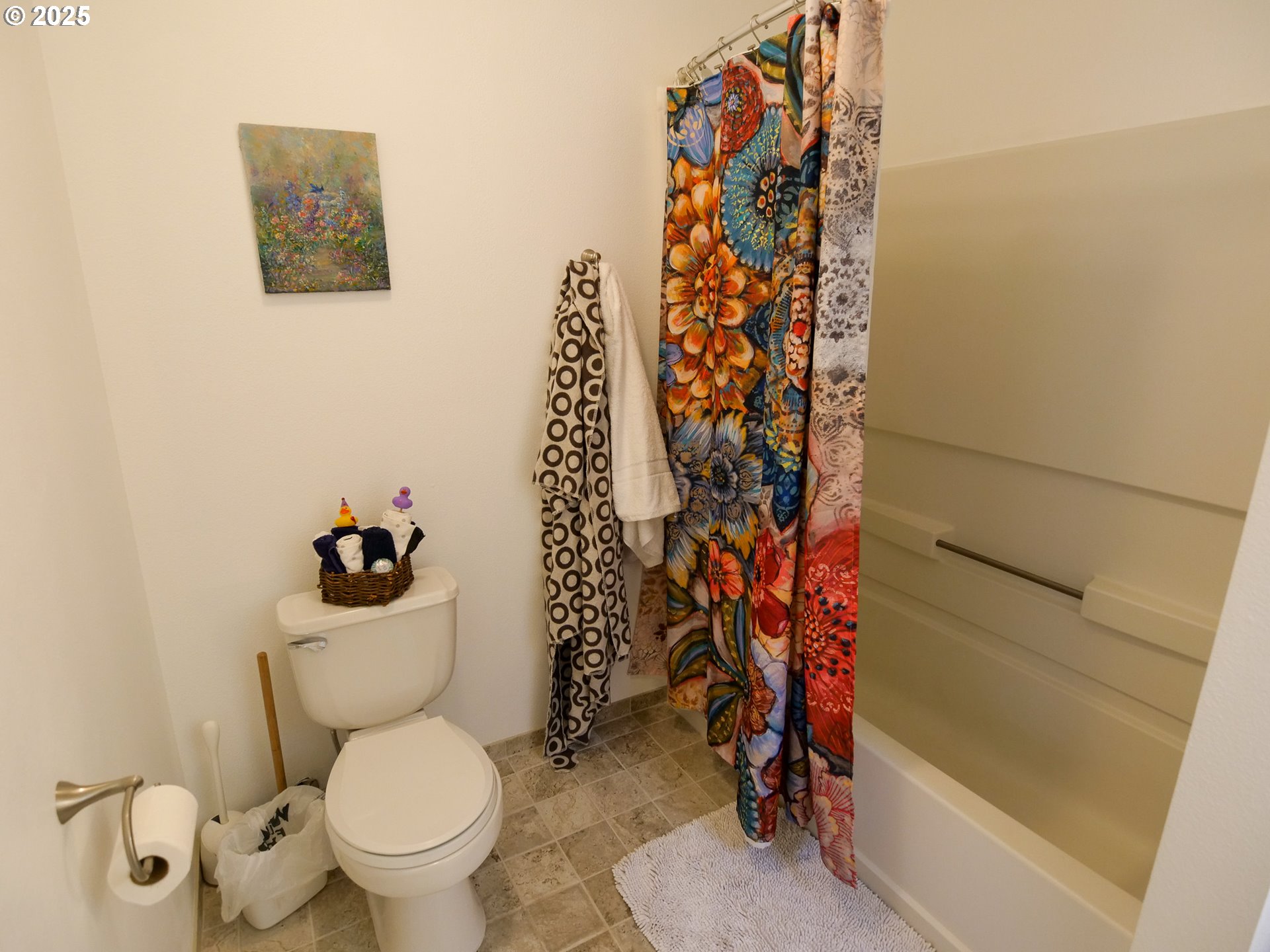 5130 Southwest Multnomah Boulevard, Unit B Portland, OR 97219 - Photo 14 of 36 a bathroom with a toilet and a shower curtain
