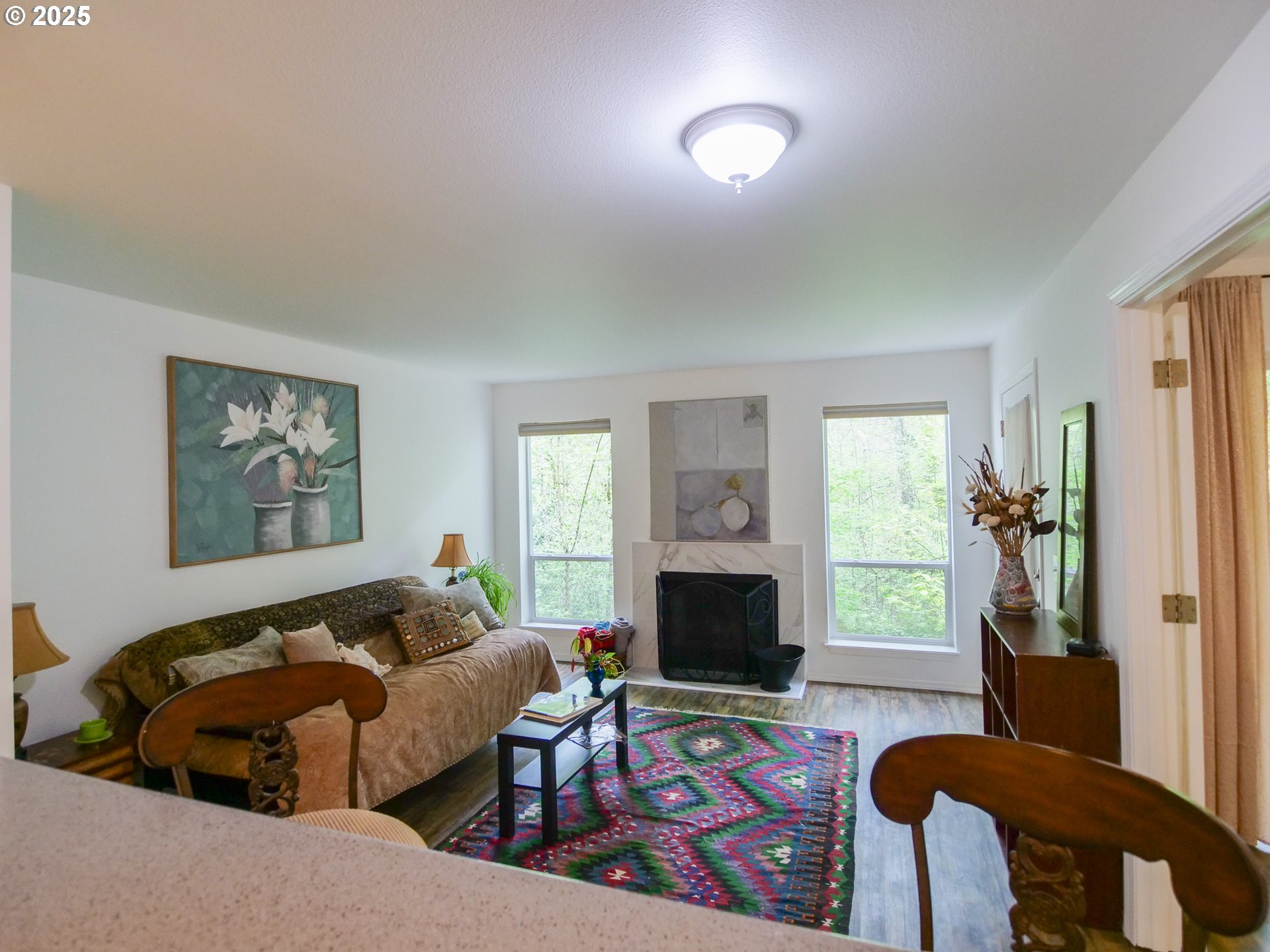 5130 Southwest Multnomah Boulevard, Unit B Portland, OR 97219 - Photo 18 of 36 a living room with furniture fireplace and a window