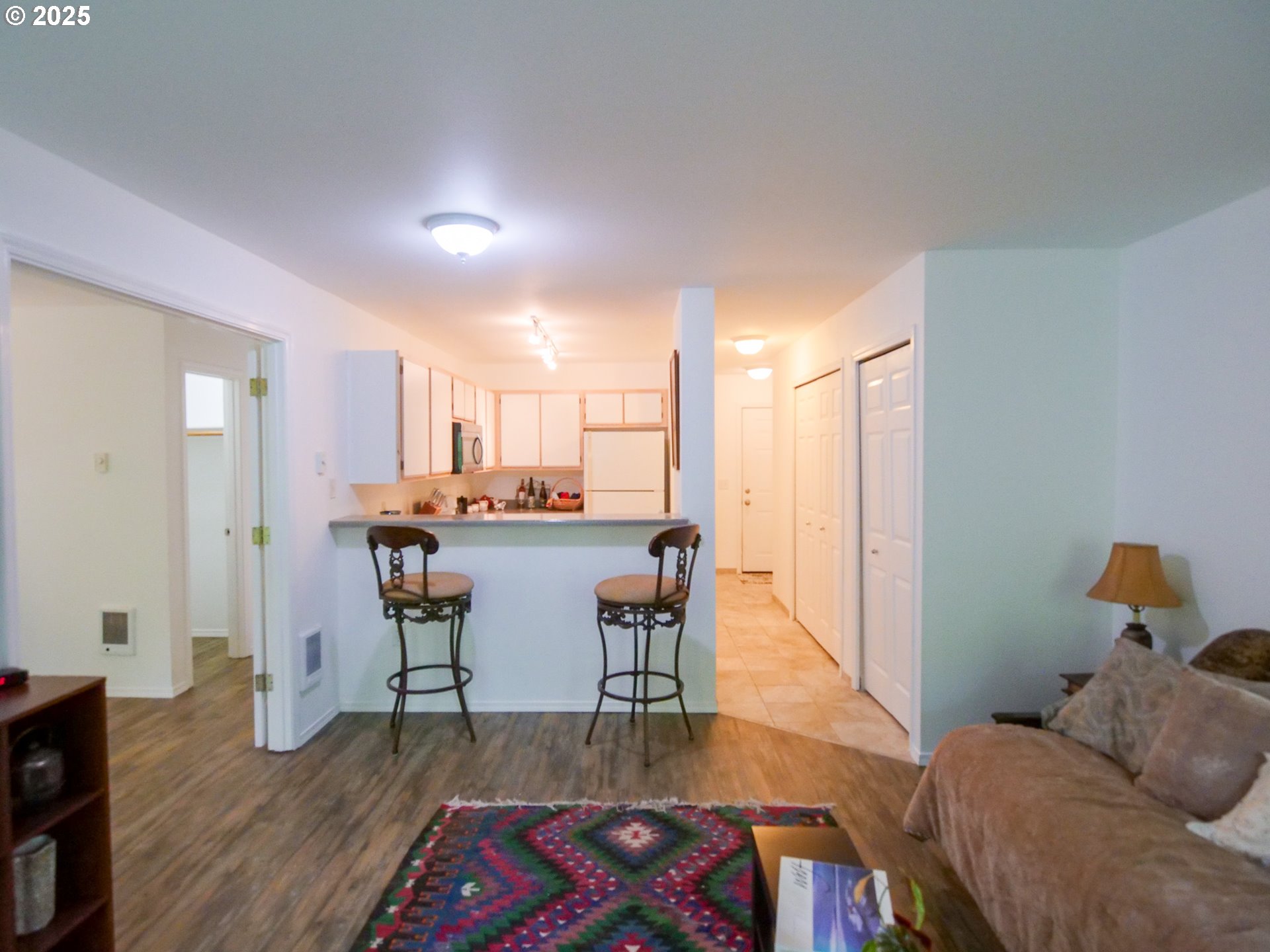 5130 Southwest Multnomah Boulevard, Unit B Portland, OR 97219 - Photo 19 of 36 a living room with furniture and a wooden floor