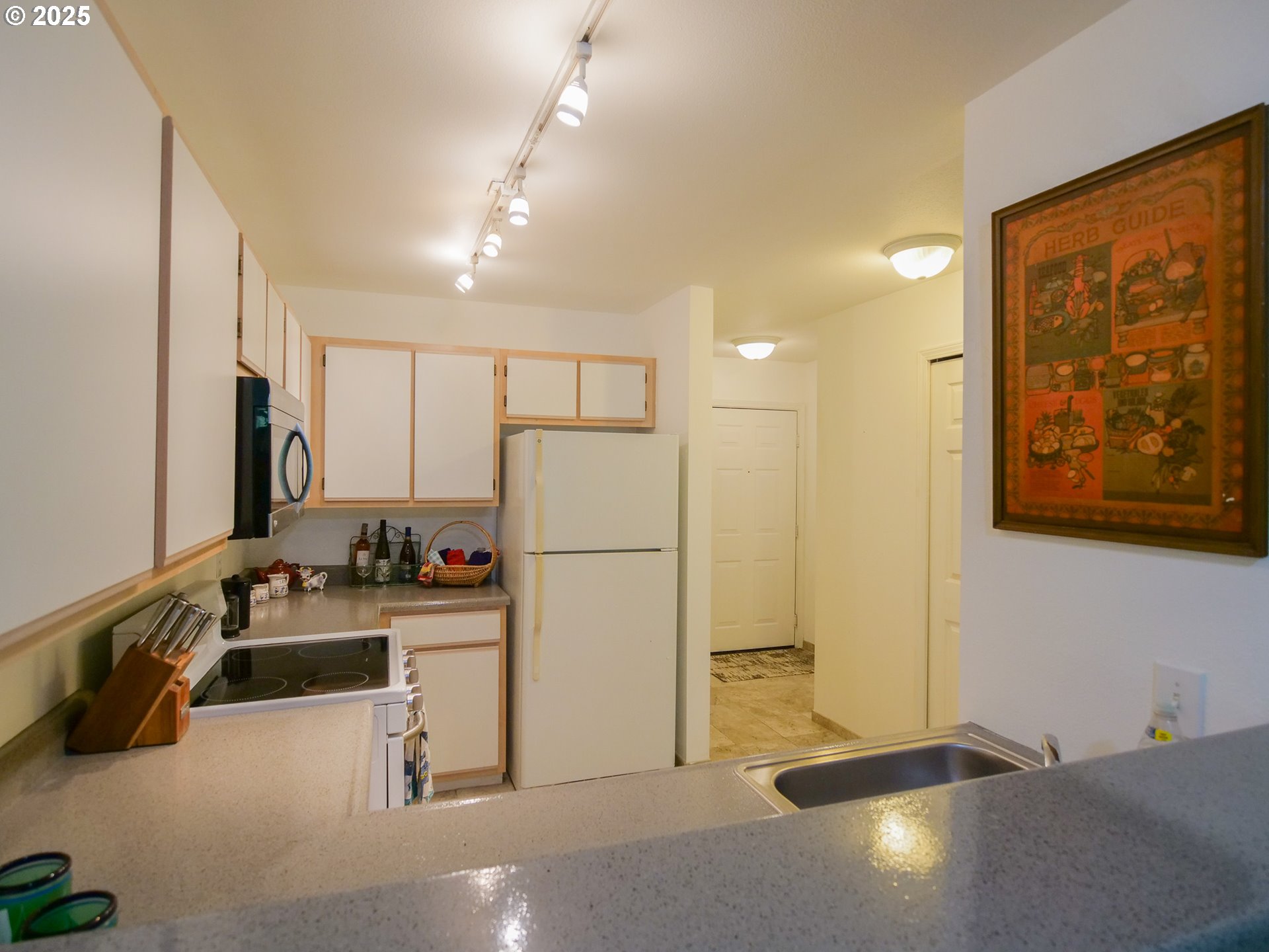 5130 Southwest Multnomah Boulevard, Unit B Portland, OR 97219 - Photo 21 of 36 a view of a kitchen with refrigerator and window
