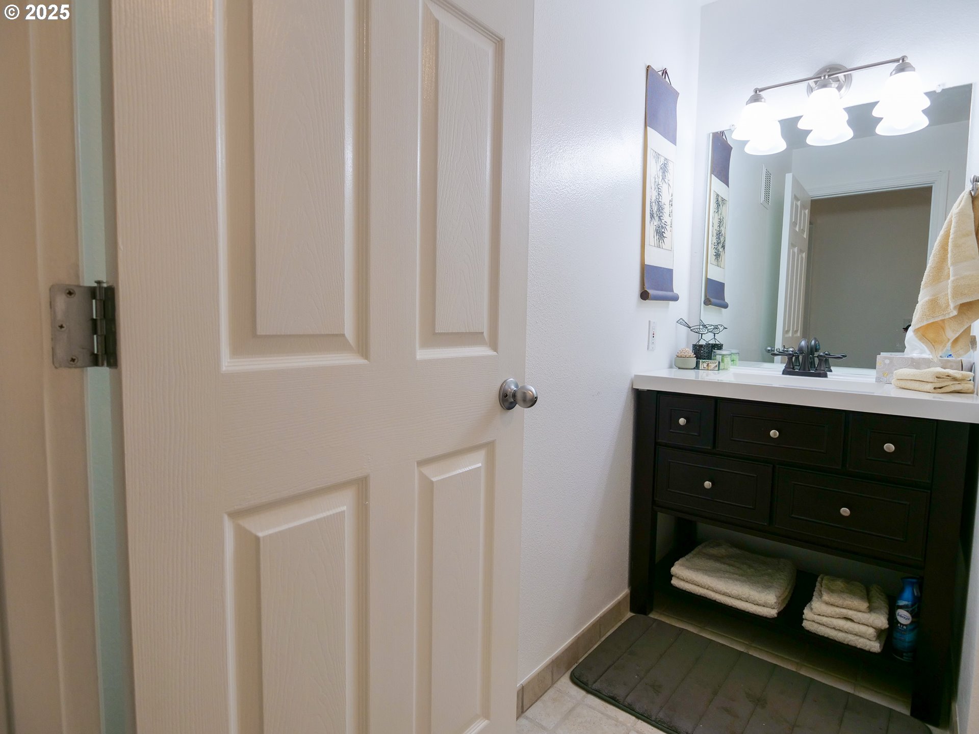 5130 Southwest Multnomah Boulevard, Unit B Portland, OR 97219 - Photo 24 of 36 a bathroom with a sink and a mirror