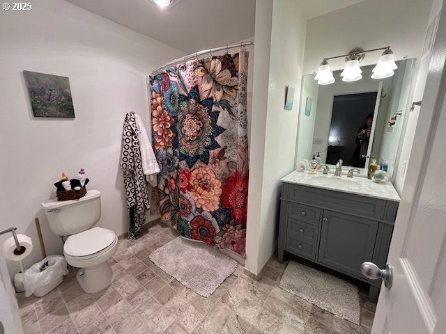 5130 Southwest Multnomah Boulevard, Unit B Portland, OR 97219 - Photo 8 of 36 a bathroom with a toilet sink and mirror