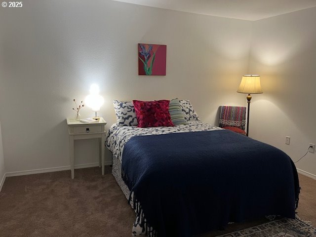 5130 Southwest Multnomah Boulevard, Unit B Portland, OR 97219 - Photo 9 of 36 a bedroom with a bed and a lamp