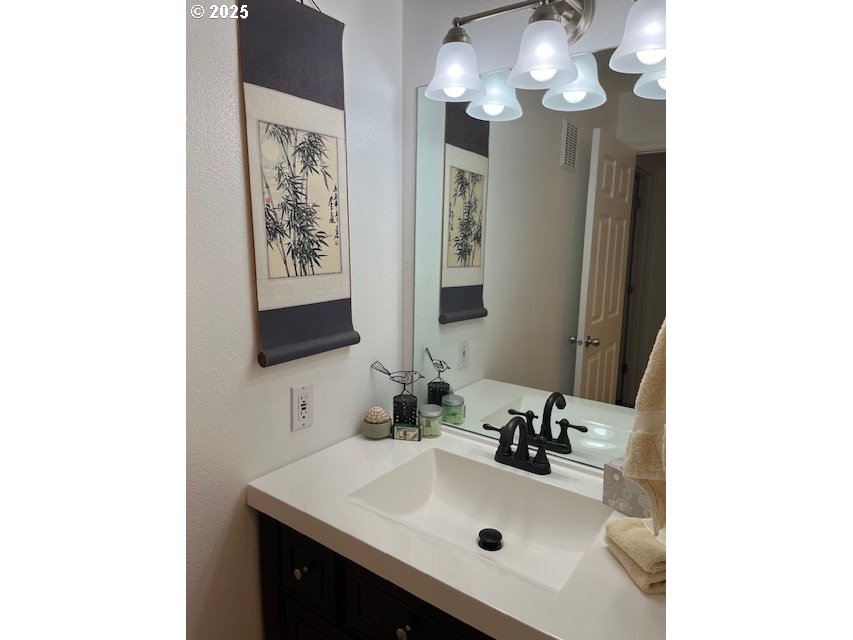 5130 Southwest Multnomah Boulevard, Unit B Portland, OR 97219 - Photo 10 of 36 a bathroom with a sink and a mirror