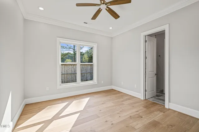 a view of an empty room with wooden floor