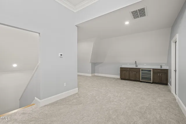 a view of an empty room with a fireplace and a window