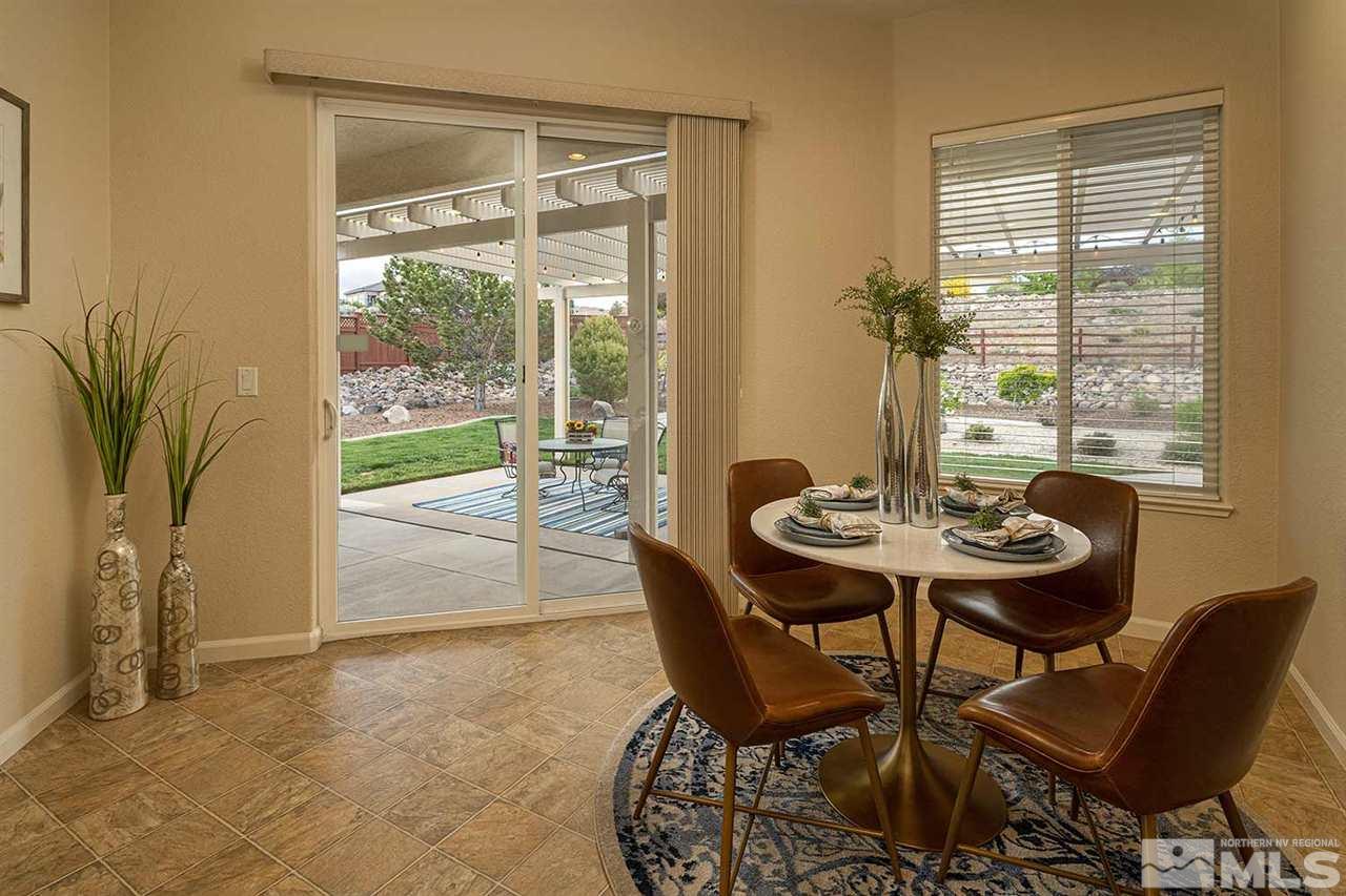 2201 South Tesuque Road Reno, NV 89511 - Photo 14 of 40 a view of a dining room with furniture and wooden floor
