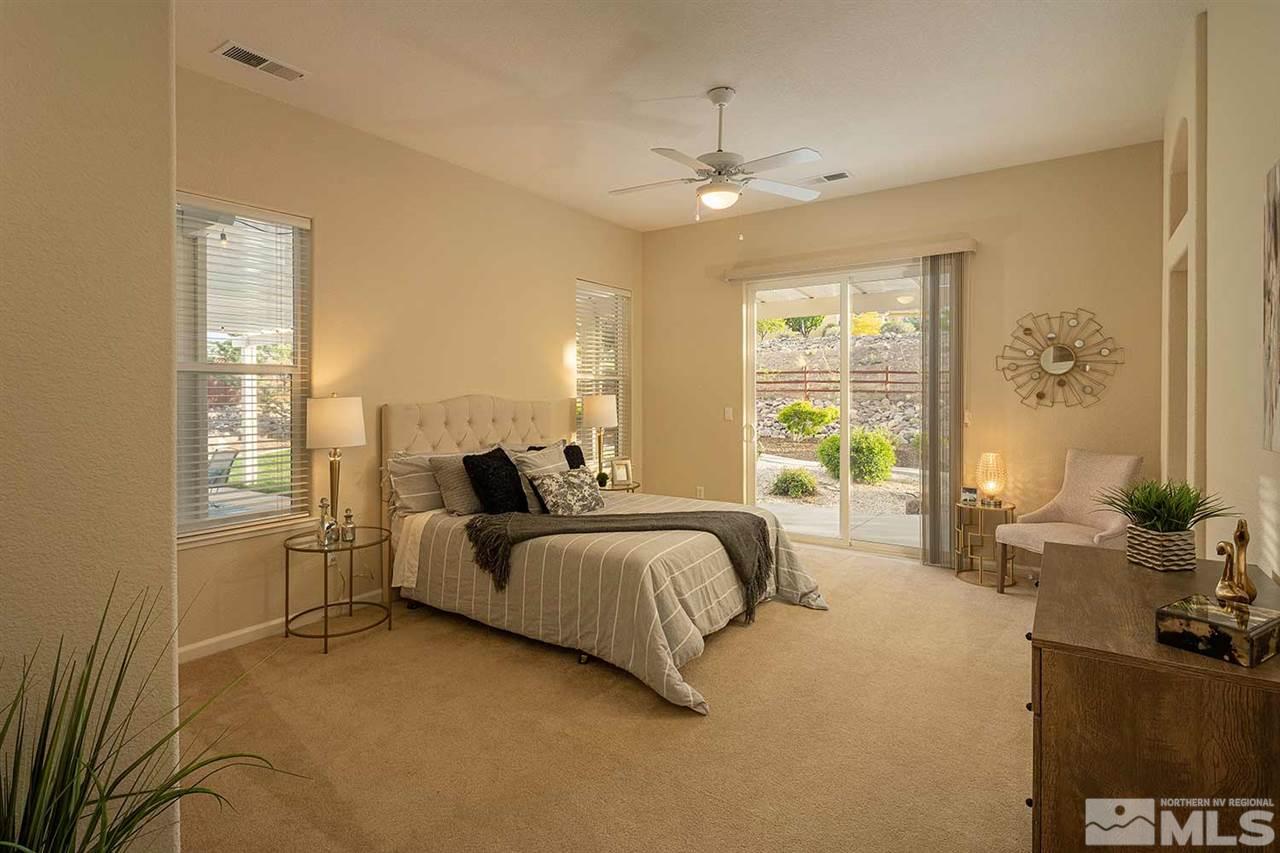 2201 South Tesuque Road Reno, NV 89511 - Photo 22 of 40 a spacious bedroom with a bed and large windows