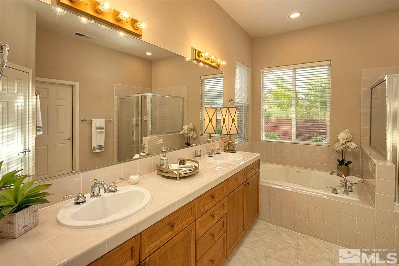 2201 South Tesuque Road Reno, NV 89511 - Photo 24 of 40 a bathroom with a tub double sink window and mirror