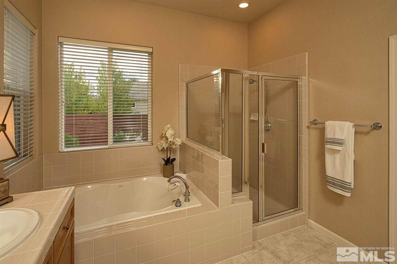 2201 South Tesuque Road Reno, NV 89511 - Photo 25 of 40 a bathroom with a tub a sink and a shower