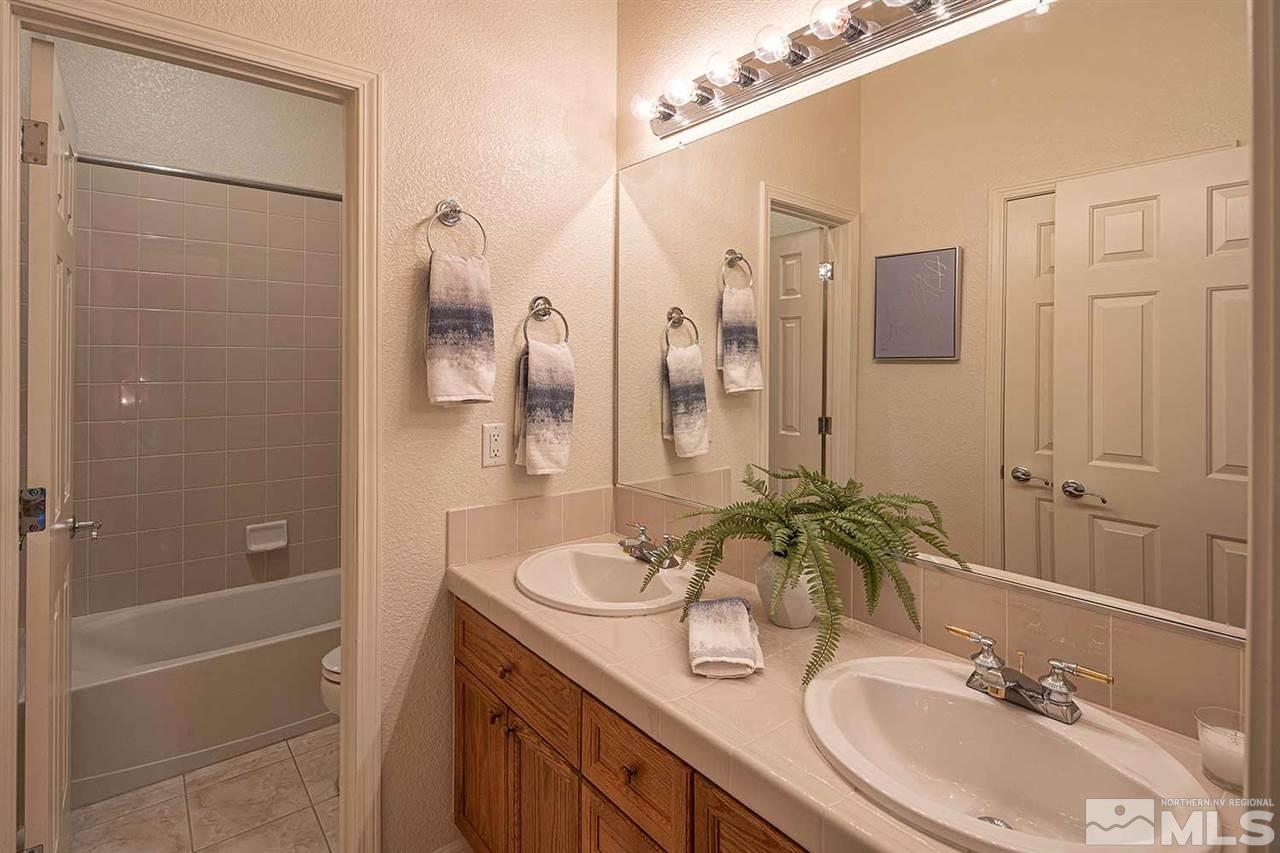 2201 South Tesuque Road Reno, NV 89511 - Photo 27 of 40 a bathroom with a granite countertop shower sink and mirror