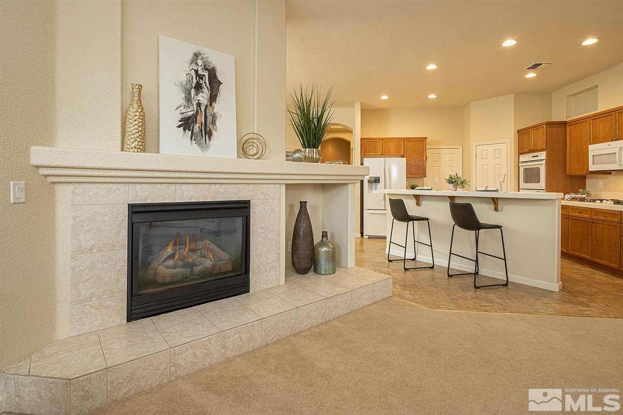2201 South Tesuque Road Reno, NV 89511 - Photo 8 of 40 a living room with furniture a fireplace and kitchen view