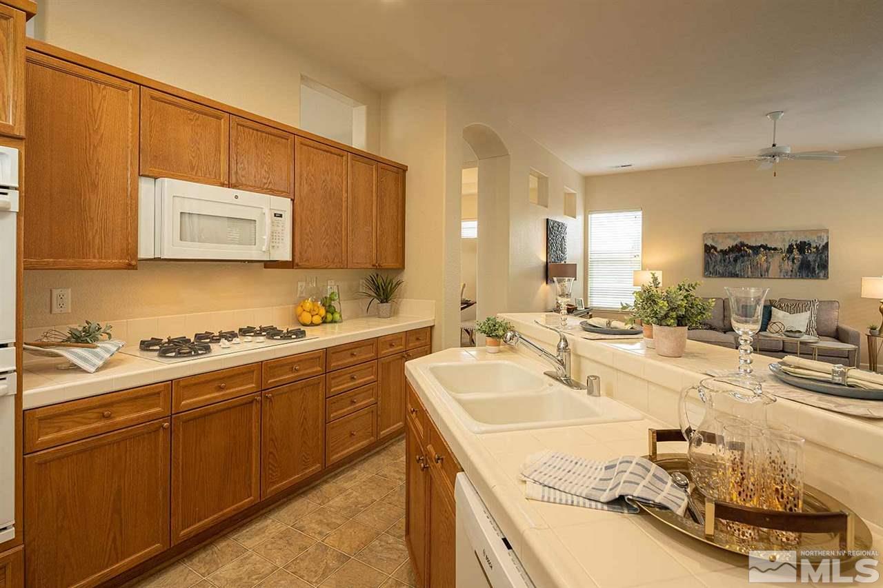 2201 South Tesuque Road Reno, NV 89511 - Photo 10 of 40 a kitchen with a sink stove and cabinets