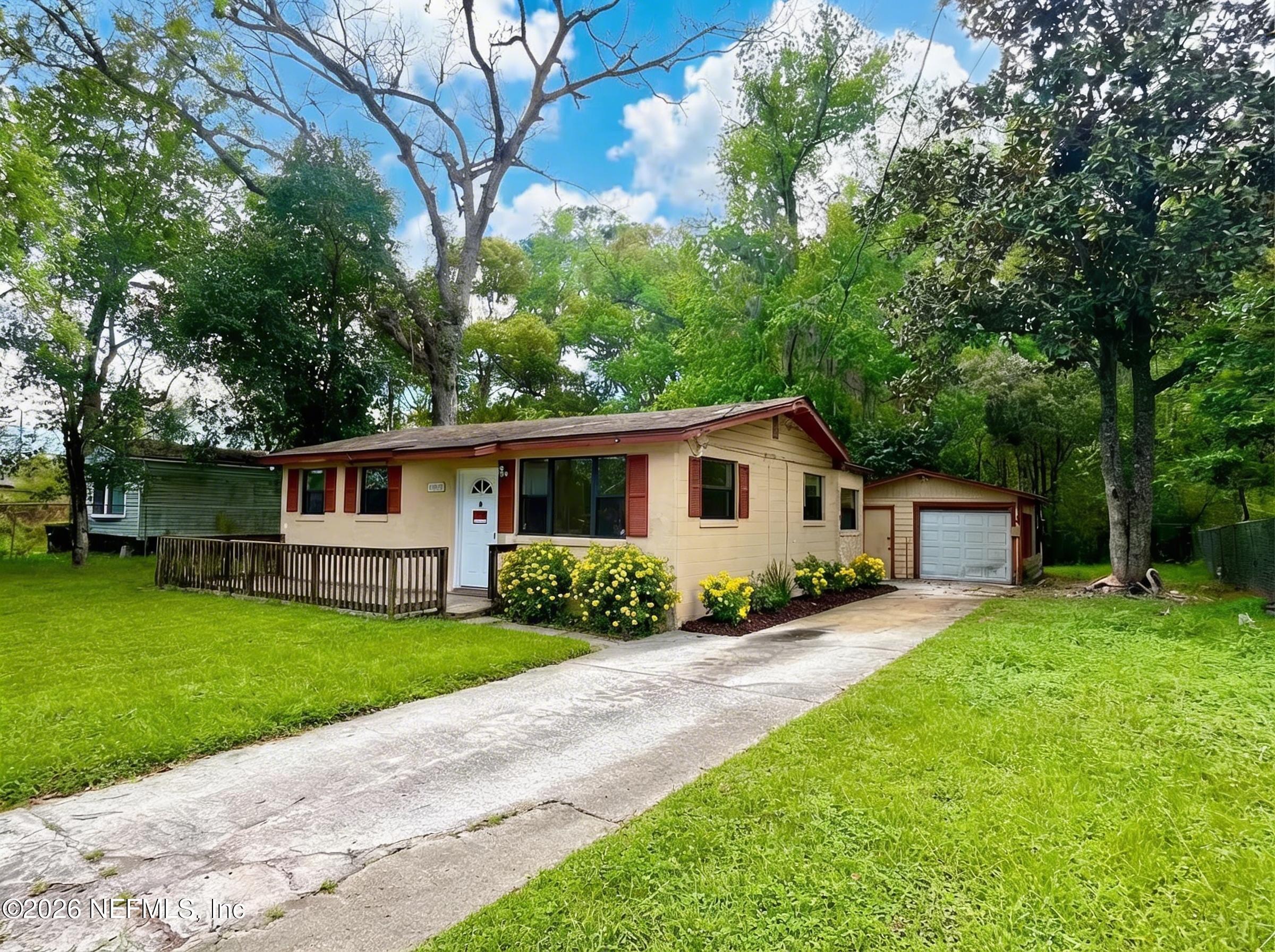 9926 Frankella Road Jacksonville, FL 32208 - Photo 3 of 18 a front view of a house with yard