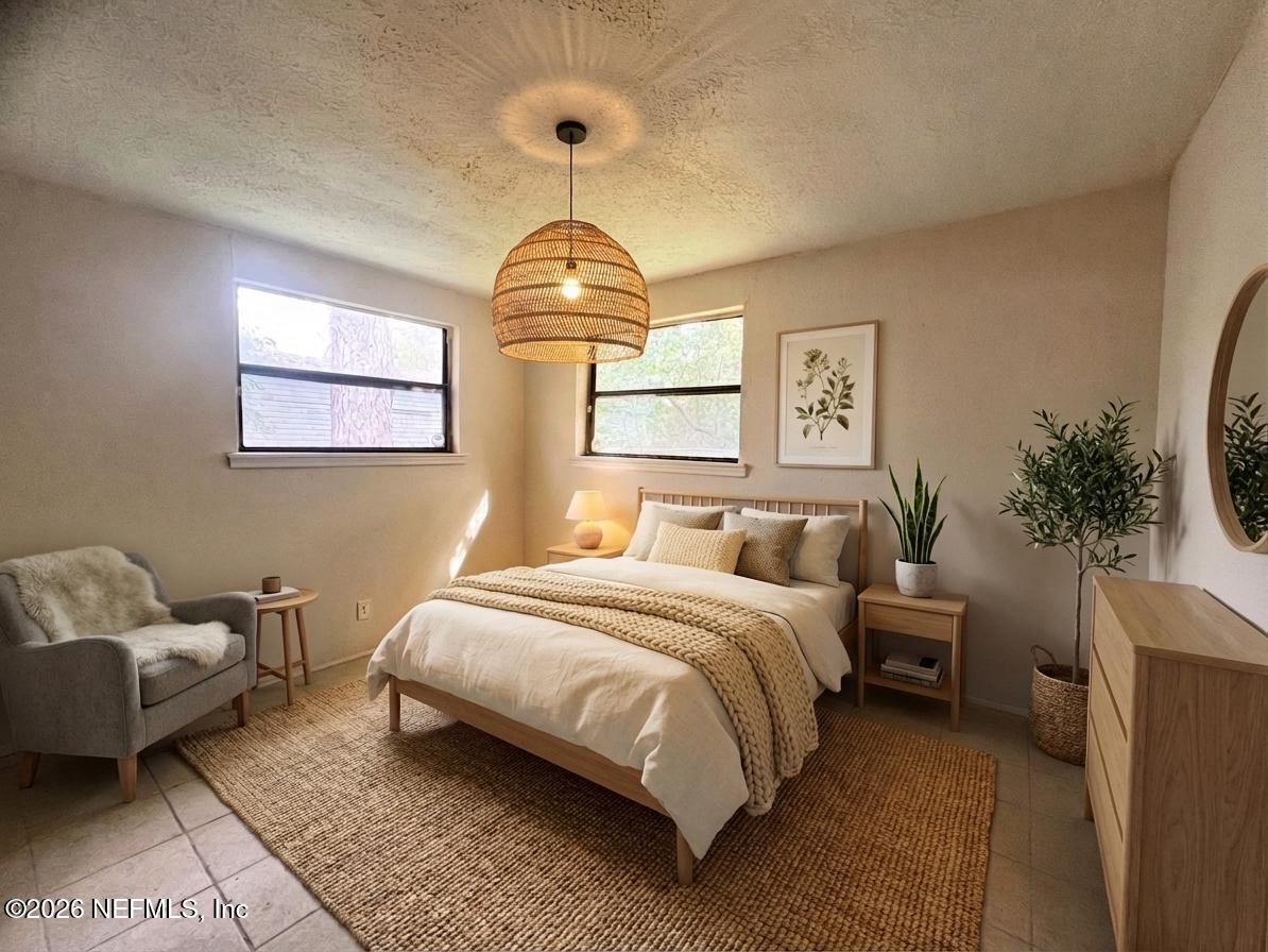 9926 Frankella Road Jacksonville, FL 32208 - Photo 6 of 18 a spacious bedroom with a bed and a chandelier