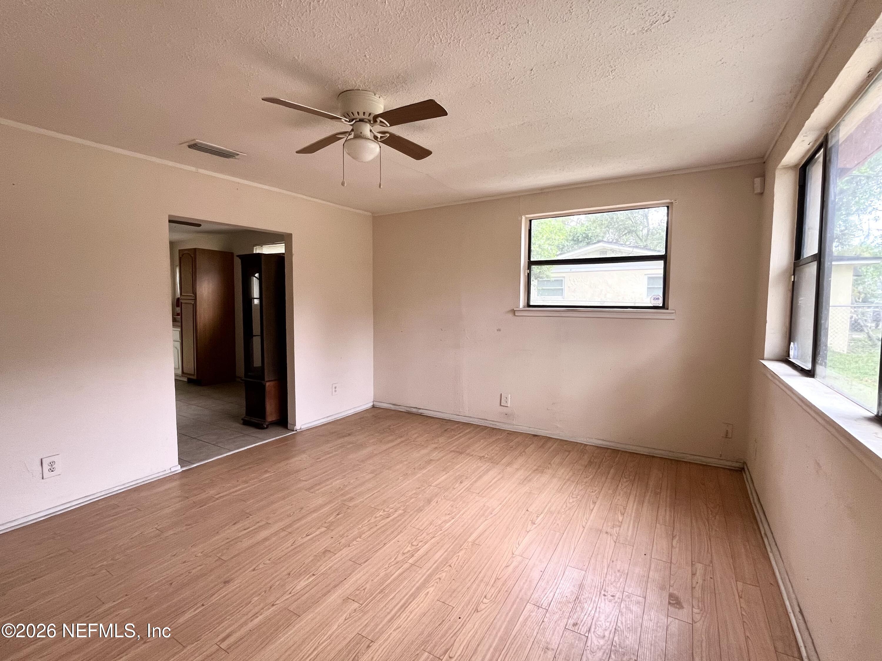 9926 Frankella Road Jacksonville, FL 32208 - Photo 9 of 18 wooden floor in an empty room with a window