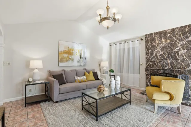 a living room with furniture and a chandelier