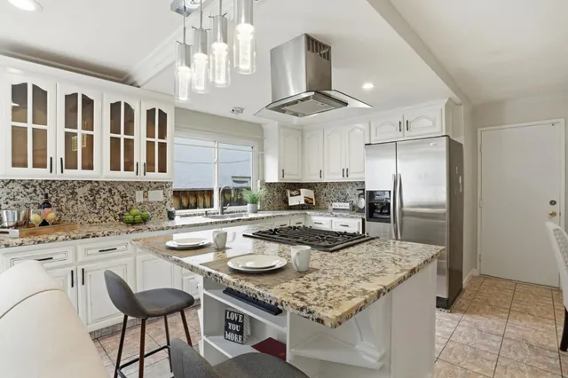 a kitchen with stainless steel appliances granite countertop a stove and a sink
