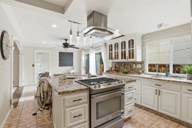a kitchen with a table chairs stove and cabinets