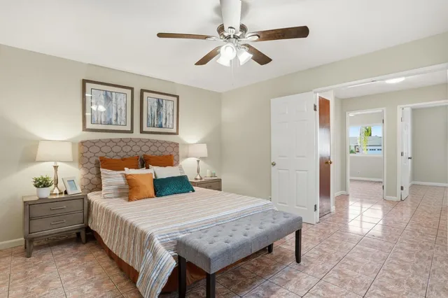 a bedroom with a bed and a chandelier