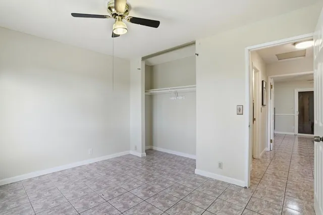 a bathroom with a granite countertop toilet sink and mirror