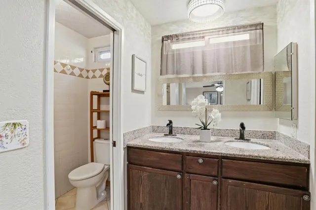 a bathroom with a granite countertop sink a mirror and a
