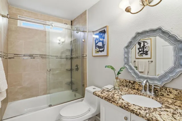 a view of a patio with table and chairs potted plants and large tree