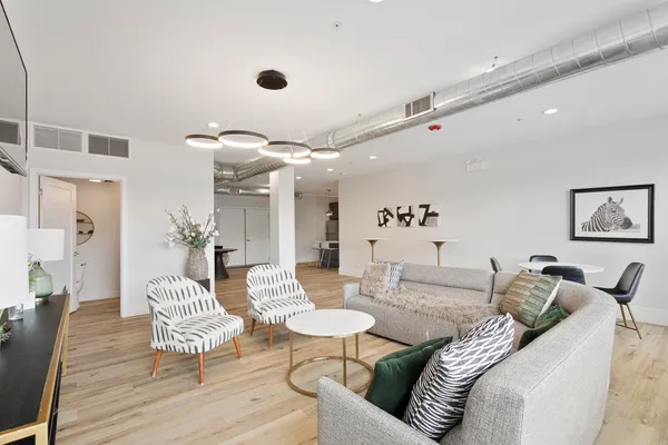 a living room with furniture and wooden floor