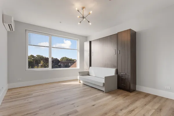 a view of a bedroom with furniture window and a ceiling fan