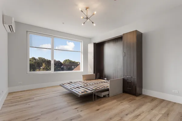 a view of a room with a bed and a window