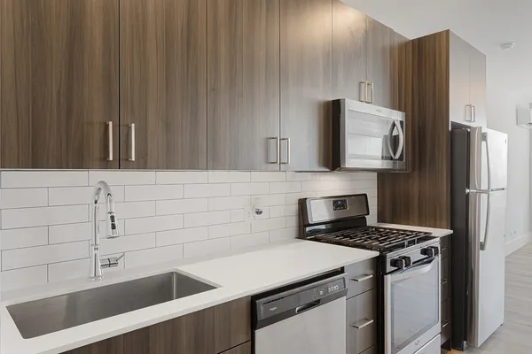 a kitchen with a refrigerator and a sink